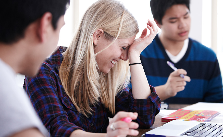 female student laughing with peers