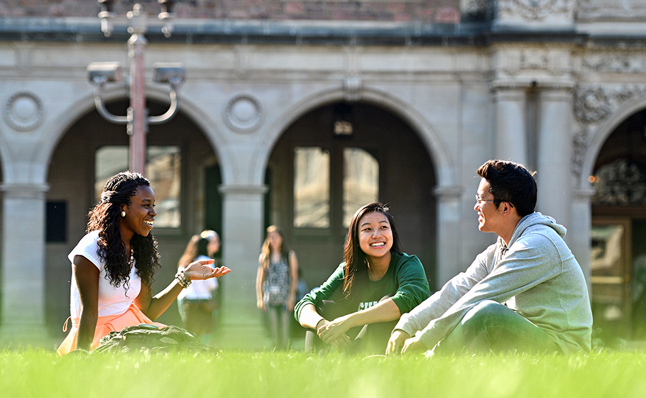 students sitting on lawn near Ridgley Hall