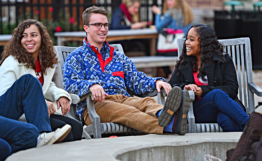 students sitting around fire pit